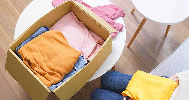 istock Woman Packing Donation clothes 2218789813