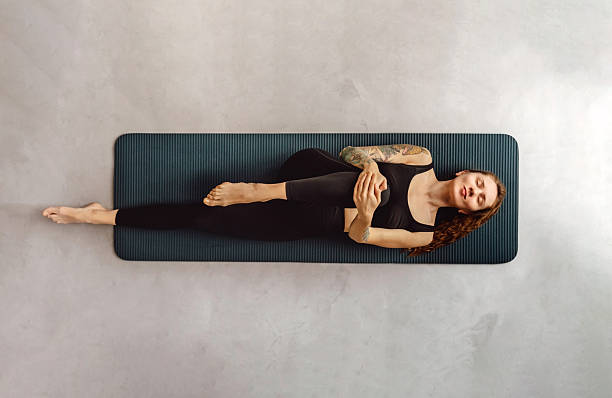 istock Woman Practicing Yoga and Doing Stretching Exercise 2218789815