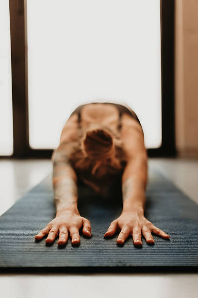 istock Woman Practicing Yoga Stretching in Child Pose 2218790162