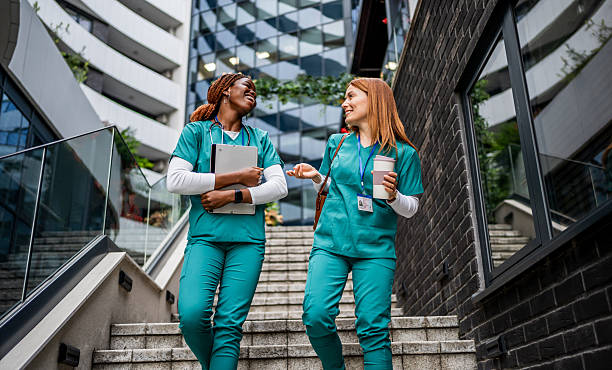 istock Two nurses walking and talking on hospital stairs 2218790413