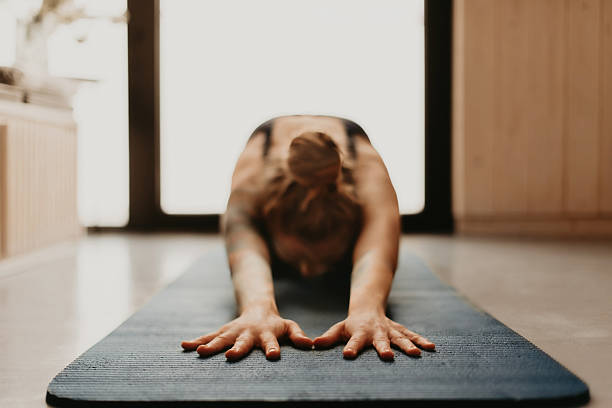istock Woman Doing Yoga Stretching in Child Pose 2218791062