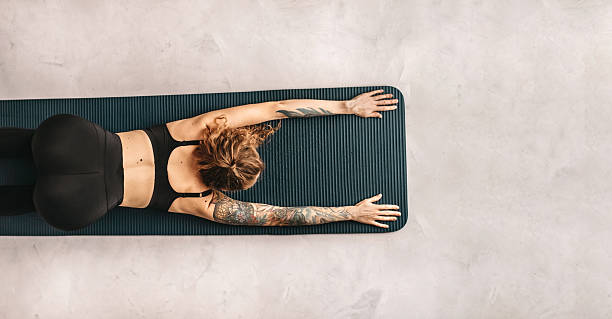 istock Woman Practicing Yoga and Stretching in Puppy Pose 2218791116