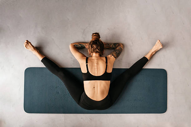 istock Woman Doing Yoga Exercise on Mat Top View 2218791136
