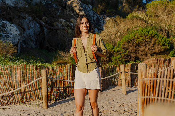 istock Tourist walking on a sandy path near the beach at sunset 2218791305