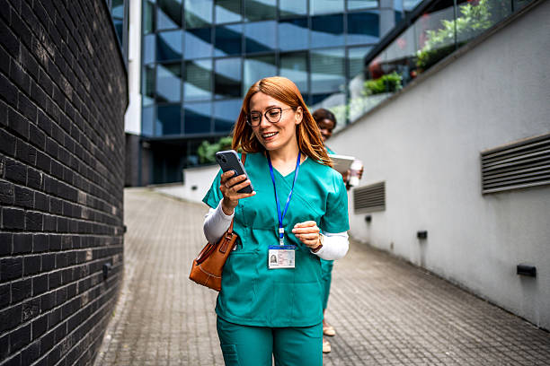 istock Nurse walking and using smartphone near hospital 2218791322
