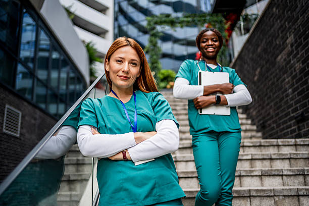 istock Two confident nurses smiling outside hospital building 2218791694