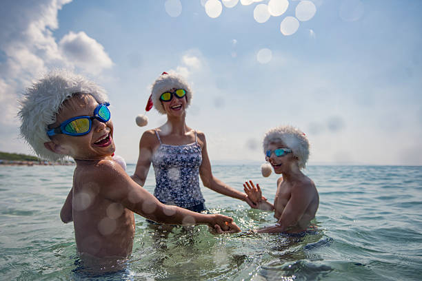 istock Children celebrating summer Christmas with a refreshing joy in tropical waters 2218791808