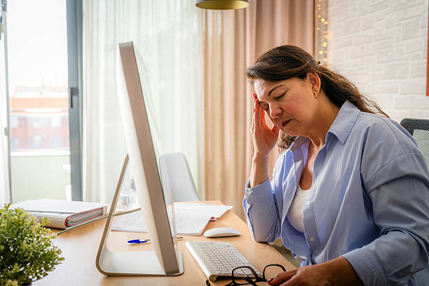 istock Eyes Fatigue. Mature woman massaging touching her head, tired after working on computer 2218794352
