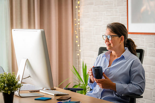 istock Businesswoman enjoying a coffee while working on computer 2218794368