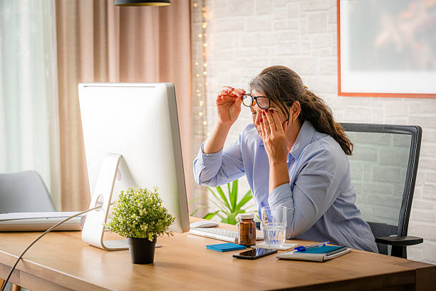 istock Exhausted and overworked woman rubbing eyes while working on computer 2218795506