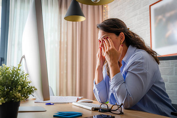 istock Tired woman touching her eyes while working on computer. Eye fatigue 2218795517