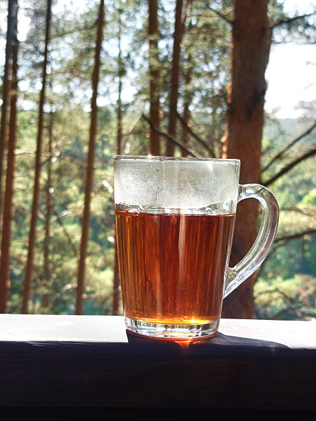 istock A transparent mug with black tea stands on the table 2218796715