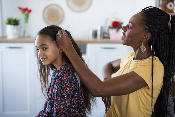 istock Mother Doing Daughter's Hair 2218799359