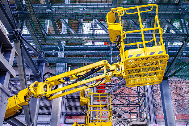 istock Construction equipment is positioned in a courtyard with safety cones and tools visible, ideal for maintenance tasks in an urban environment 2218799946