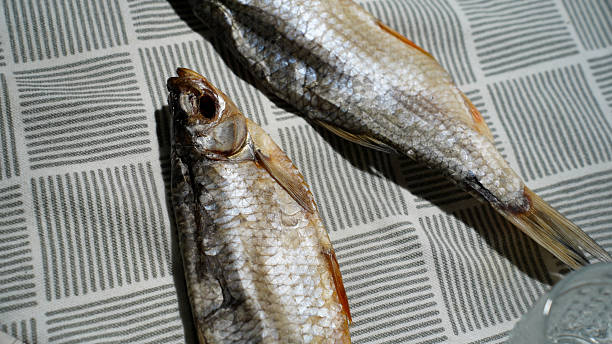 istock Dried Fish on Patterned Tablecloth – Traditional Eastern European Snack 2218800069