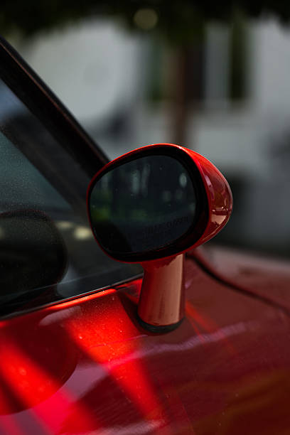 istock Side rearview mirror on a red car, on the side 2218800090
