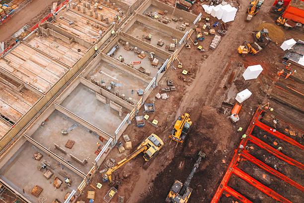 istock Aerial view from drone at Heavy machinery and workers are busy at a construction site where a multi-story building frame is being erected 2218803065