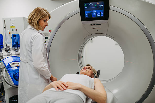 istock Doctor operating CT machine and preparing patient for scan 2218804365