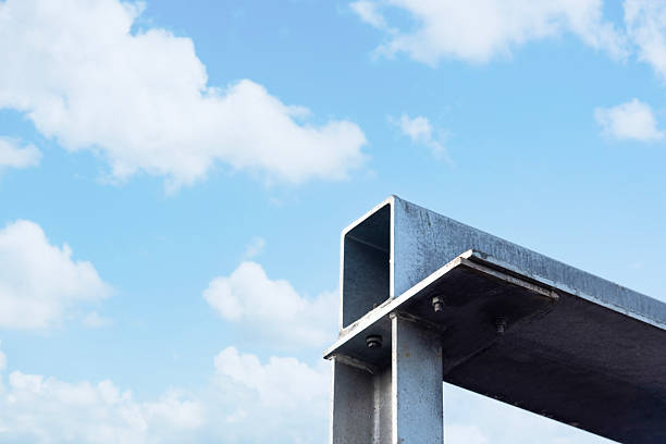 Close-up of steel frame structural elements column post and beam under blue sky