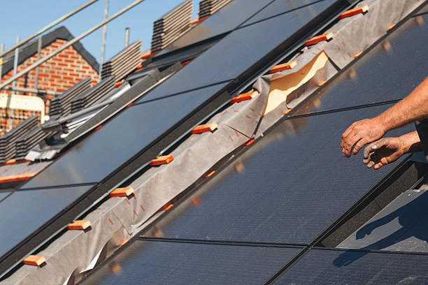 istock Construction worker roofers installing roofing tiles on residential building 2218804408