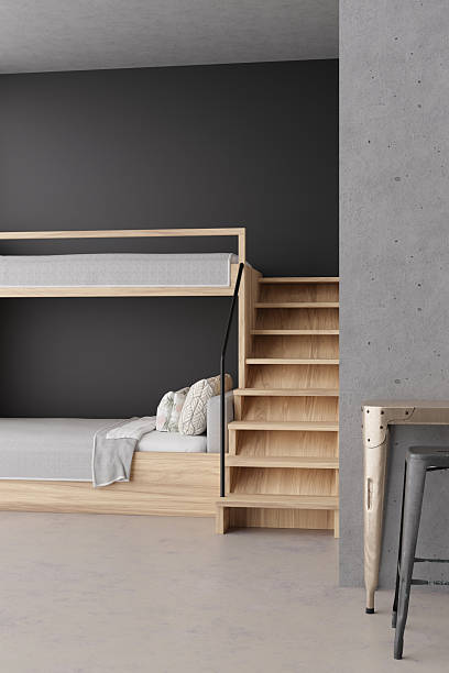 istock This hostel interior features detailed 3D rendering of bunk beds and wooden steps. The minimalist design showcases comfortable sleeping arrangements and stylish decor, perfect for travelers 2218805875
