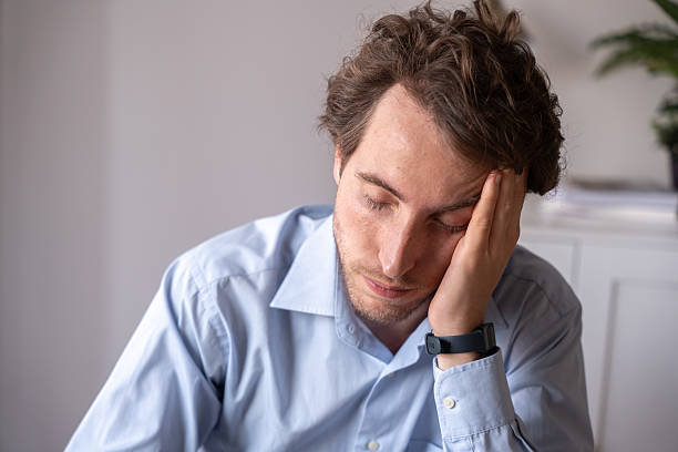 istock Tired man at the office after a long and intense workday 2218809478