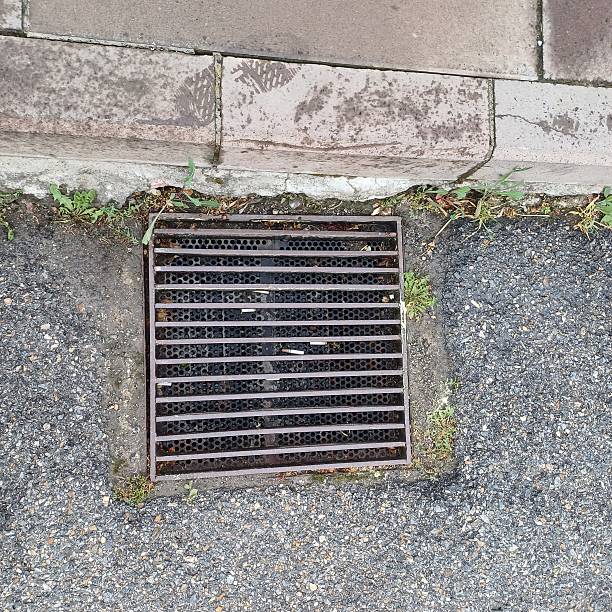 istock Metal Drain Cover on Asphalt 2218809955