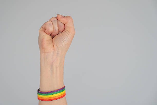 istock Woman's fist with rainbow bracelet. 2218812497