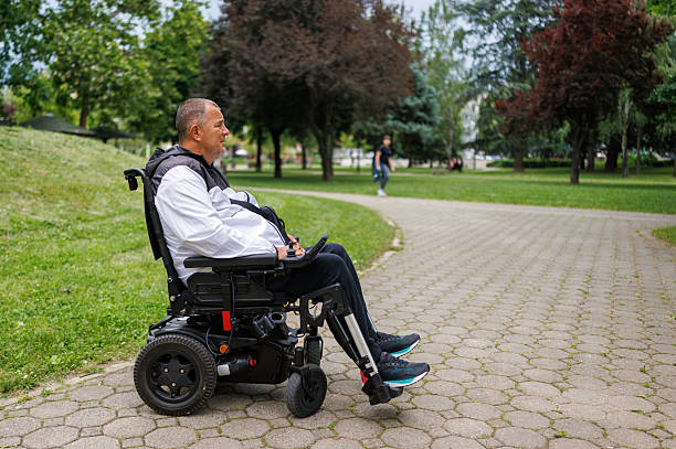 istock Man Taking a Stroll in Wheelchair on Paved Path 2218812841