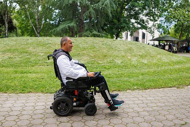 istock Man Taking a Stroll in Wheelchair on Paved Path 2218812954