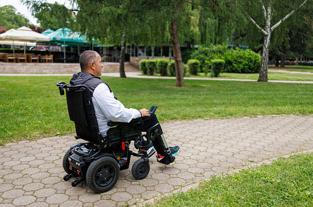 istock Man Taking a Stroll in Wheelchair on Paved Path 2218813110