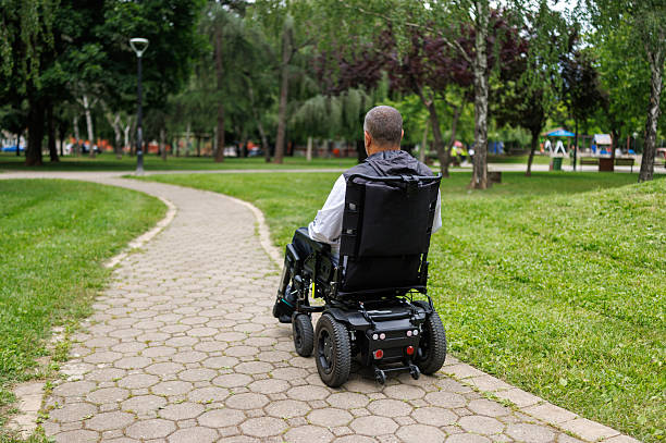 istock Man Taking a Stroll in Wheelchair on Paved Path 2218813138