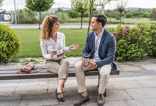 istock Business people chatting on a bench during coffee break 2218814063