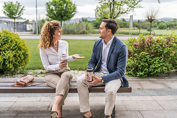 istock Business people chatting on a bench during coffee break 2218814170
