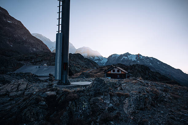 Breathtaking mountain road winding through the Susten Pass in the Swiss Alps, captured on a scenic summer road trip. Dramatic alpine peaks, lush green valleys, and clear blue skies create a stunning natural landscape. Ideal for travel, adventure, freedom, and nature concepts.