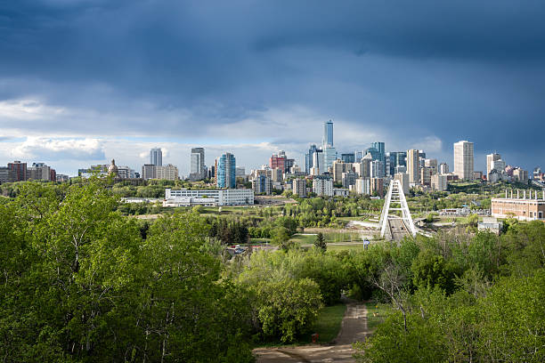 Edmonton,Canada, May 13, 2025: Cityscape downtown view with heavy rain clouds and sunlight from the cleared sky west