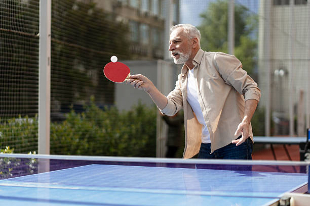 istock Senior man playing ping pong outdoors 2218823026