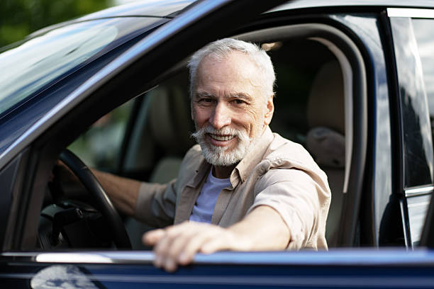 istock Happy senior man driving his new car 2218823038