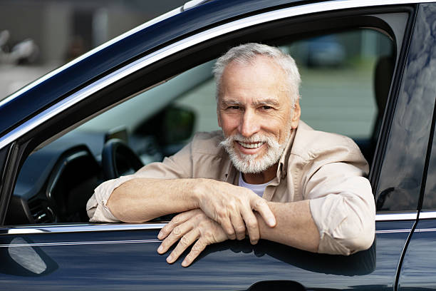 istock Happy senior man driving his new car 2218823044