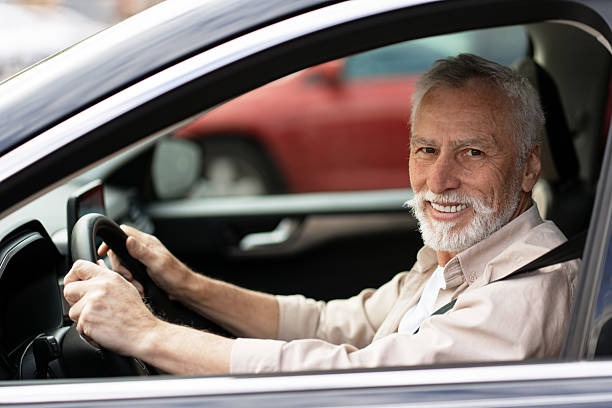istock Happy Senior Man Driving Modern Car Smiling At Camera 2218823075