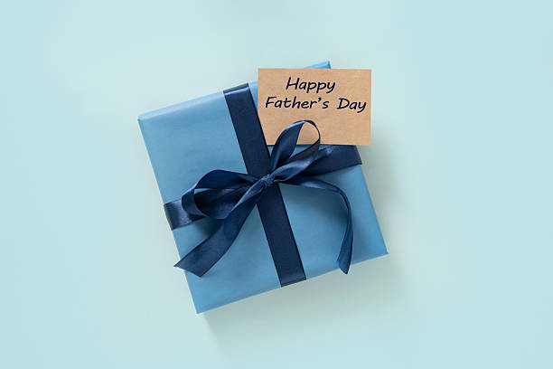 istock Happy Fathers Day gift box and label on blue background. View from above. 2218824412