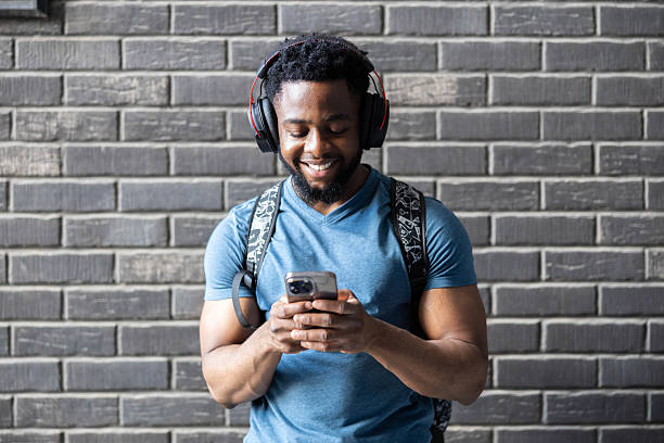 istock Man Enjoys Music While Checking Phone 2218824940