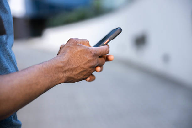 istock Man texting on smartphone outdoors 2218825002