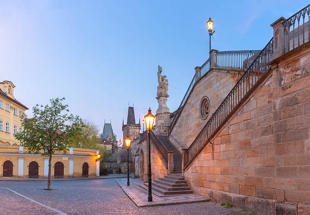 Charles Bridge with towers and sculptures at dawn in Prague, Czech Republic