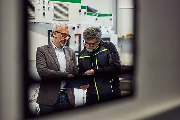 istock Two Professionals Collaborating in a Modern Industrial Workspace 2218829694