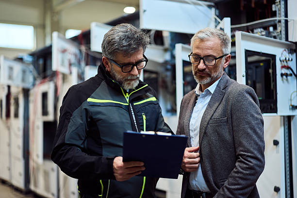 istock Engineers Reviewing Technical Document in an Industrial Facility With Modern Equipment 2218829704