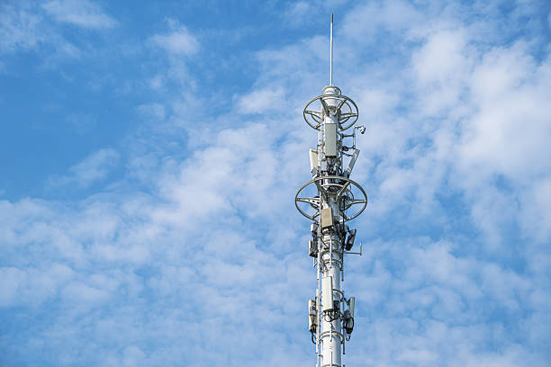 5G telecommunications base station tower with sunny blue sky background