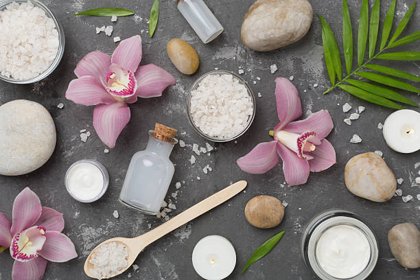 istock Composition with orchids and massage stones on concrete background, top view 2218832561
