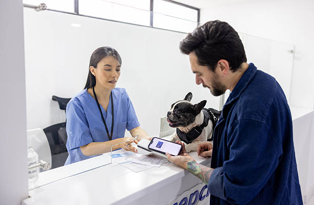 istock Man making a mobile payment at the veterinary clinic 2218833116