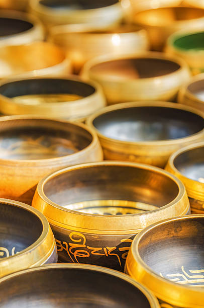 A selection of brass Tibetan meditation bowls, utilized for sound healing and relaxation techniques